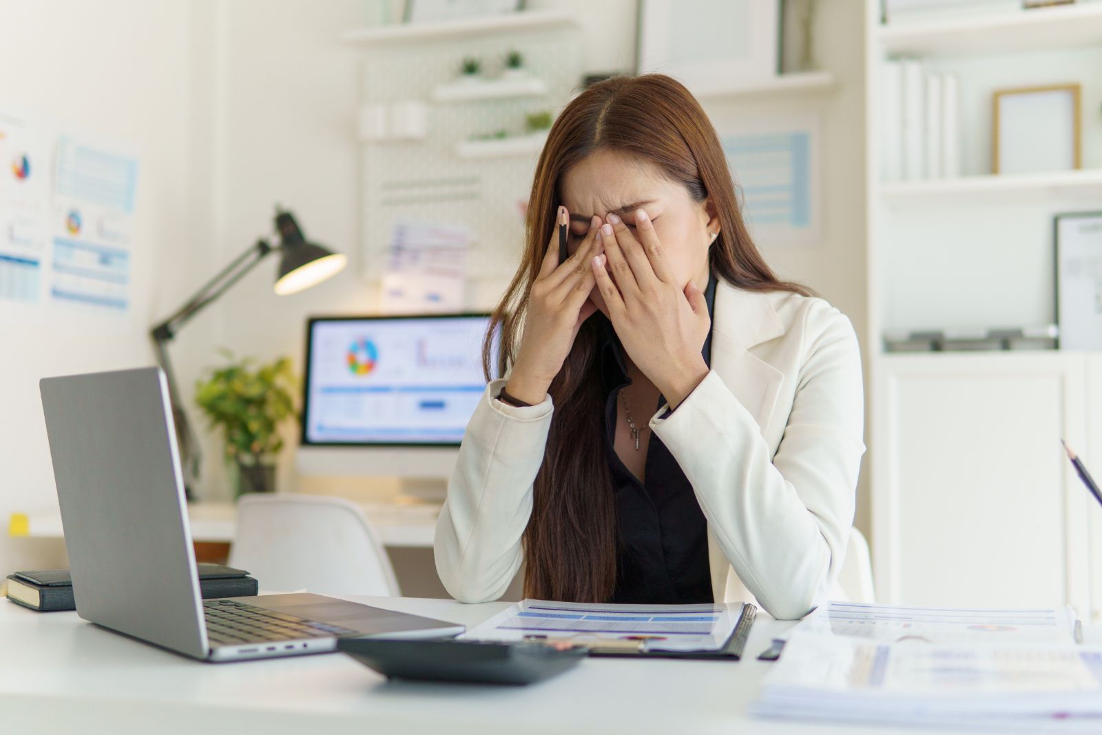 Overwhelmed person holding their head at home
