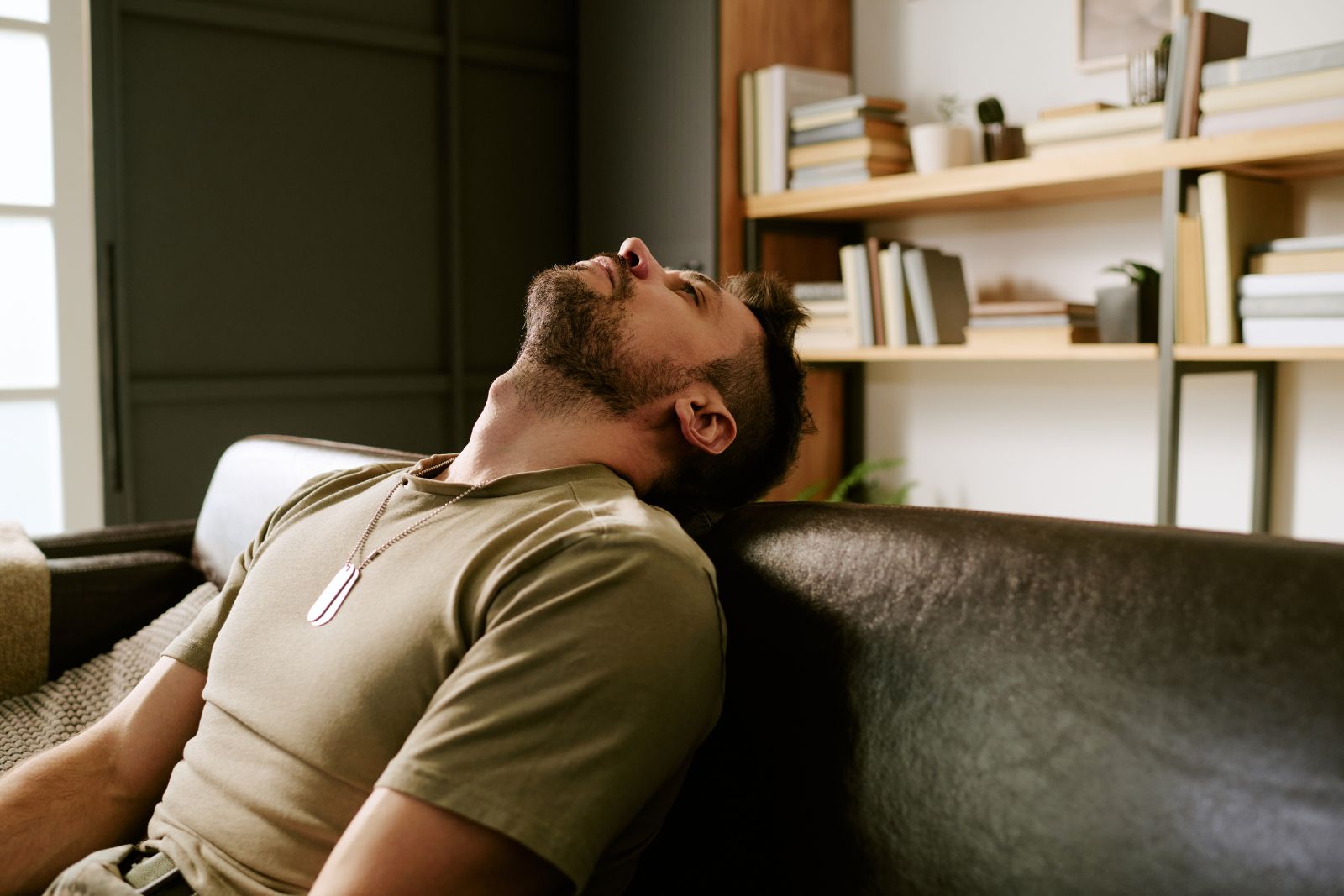 Man looking frustrated and emotionally drained in a quiet room