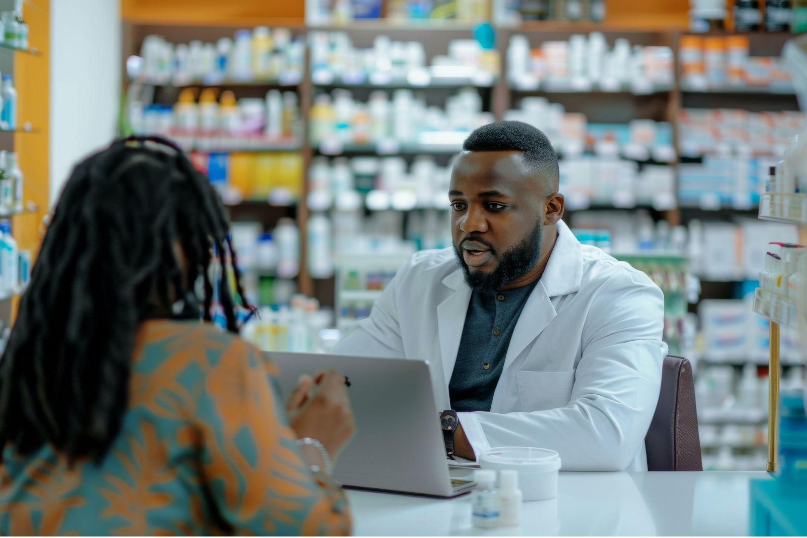 Healthcare professional explaining a naloxone nasal spray device to an adult